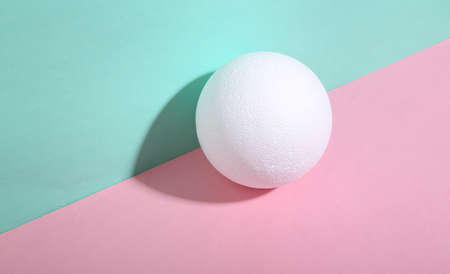 Ball on blue-pink background. minimalism. trendy shadow. creative layout.