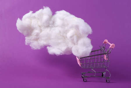 Shopping trolley with cloud on purple background. creative ideas. minimal concept.
