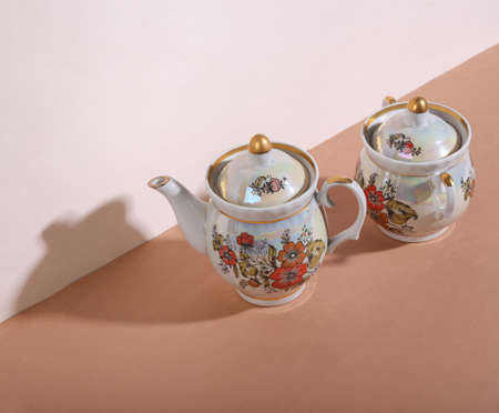 creative still life. Retro teapot and sugar bowl on beige brown background. minimalism. trendy...