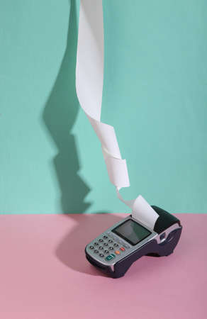 Pos terminal on blue-pink background. minimalism. trendy shadow. creative layout.