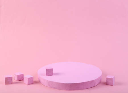 Pink podium with cubes on pink background. Platforms for product presentation, mock up background. Abstract composition in minimal design, pastel colors trend. geometric shapes.の写真素材