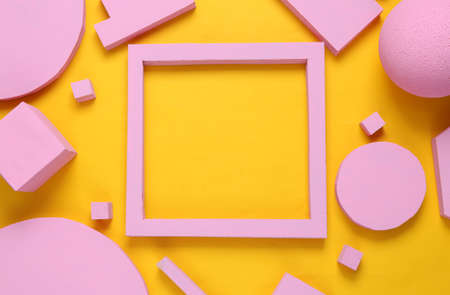 Layout composition of pink geometric shapes and empty frame for copy space on yellow background. flat layの写真素材