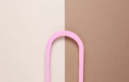 Minimalistic composition of a pink arch on a buffy brown backgroundの写真素材