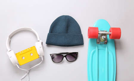 Hipster outfit on gray background. Youth flat lay still life