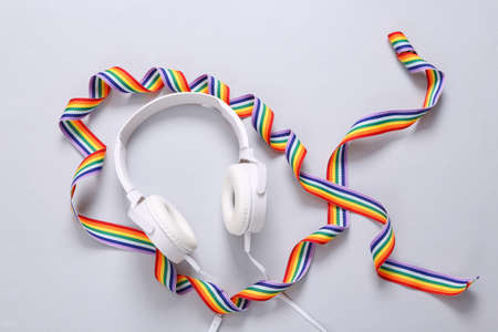 Stereo headphones with rainbow ribbon on gray background. LGBT community. top viewの写真素材