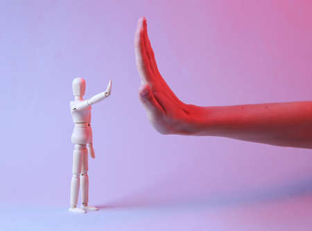 High-five female hand and puppet in red blue neon lightの写真素材