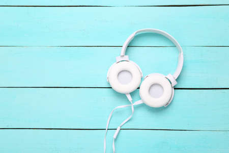Stereo headphones on a blue wooden background. top viewの写真素材