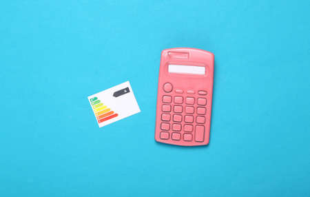 Calculator with graph class of energy consumption on blue backgroundの写真素材