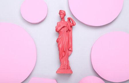 creative layout. Pink Antique greek goddess statue with circles podiums on gray background. minimalism. flat lay. top view.の写真素材