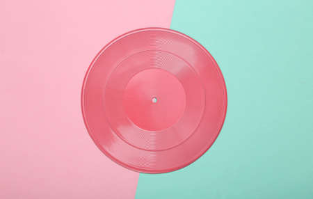 creative music layout. Pink vinyl record on pink blue background. minimalism. flat lay. top view.の写真素材