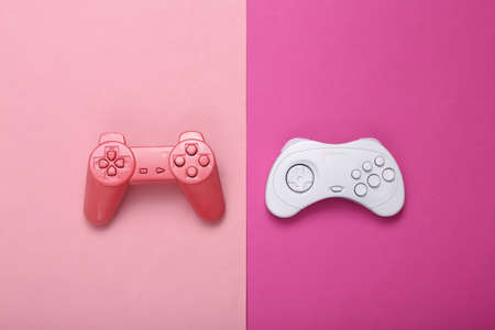 creative gaming layout. Retro gamepads on pink background. minimalism. concept art. Modern still...