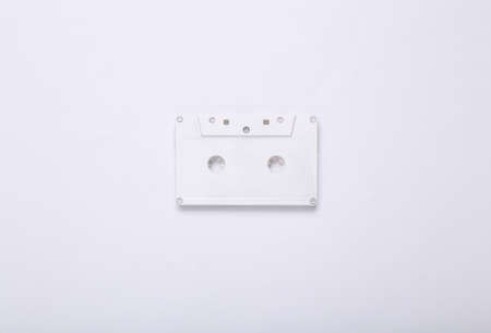 creative music layout. White retro audio cassette on white background. minimalism. concept art. Modern still life. flat lay. top view.の写真素材