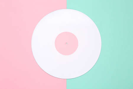 Music creative layout. White vinyl record on pink blue background. top view. flat layの写真素材