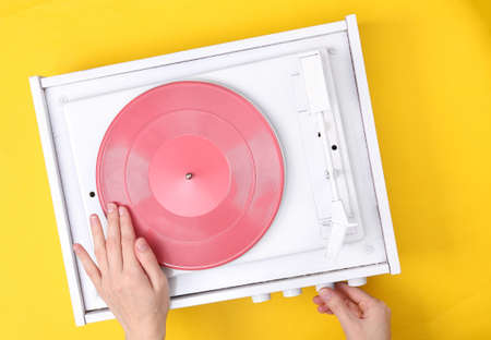 DJ Turntable, Hand Placing Tonearm on white Vinyl Record. music concept. top view