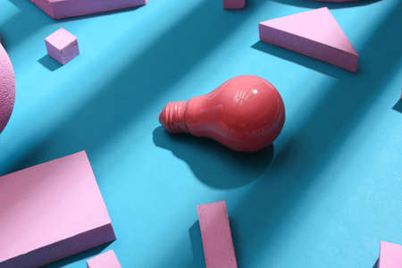 Pink lightbulb with pink geometric shapes on blue background with trendy striped shadow. creative...