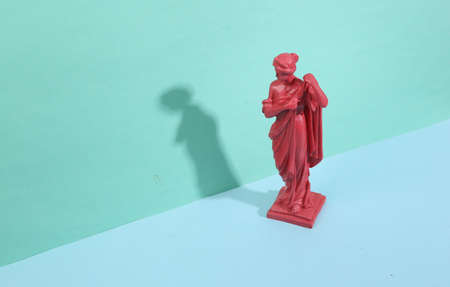 Antique goddess statue on blue background with trendy shadows. creative layout. Minimalistic still...