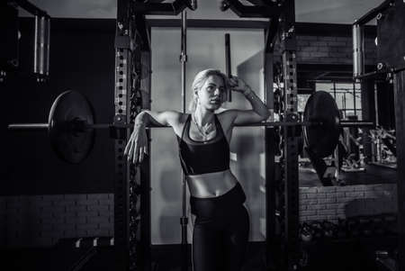 Fit woman posing at the barbell. healthy lifestyle. Bodybuilding and Fitnessの写真素材