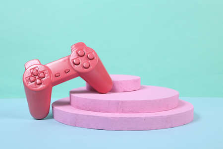 Pink gamepad on pink podium. Tournament and victory. concept art. creative layout. minimalismの写真素材