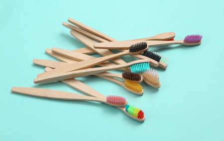 Many Eco-friendly bamboo toothbrushes on blue background.の写真素材
