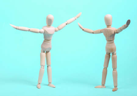 Two happy wooden puppets on a blue backgroundの写真素材