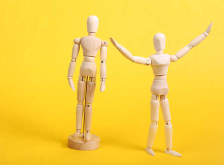 freedom concept. Two puppets on a yellow backgroundの写真素材