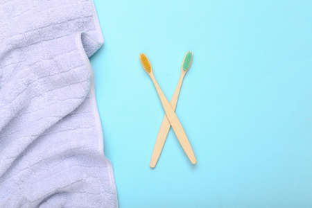 Eco-friendly bamboo toothbrush with towel on blue background.の写真素材