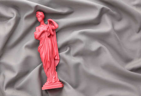 Antique pink statue on a gray silk background. beauty conceptの写真素材