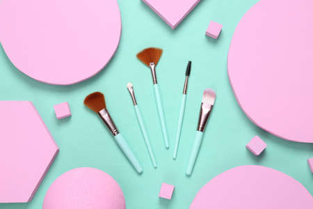 Make up brushes with different geometric shapes on blue background. minimalism. creative beauty layoutの写真素材