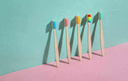 beauty and fashion minimalist scene. Eco-friendly bamboo toothbrushes on blue pink pastel background with trendy shadows. creative layoutの写真素材
