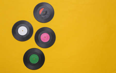 Vinyl records on yellow background. top view. Minimalist music conceptの写真素材