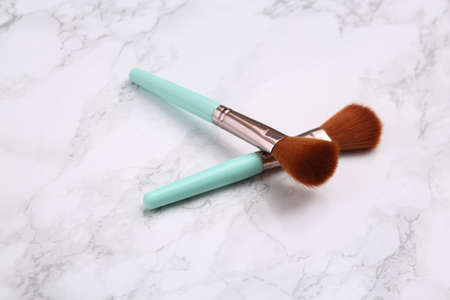 Makeup brushes on marble surface. beauty products