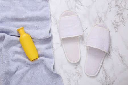 bathroom accessories. Towel, shampoo and slippers on marble backgroundの写真素材