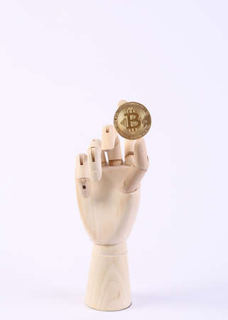 Wooden hand holding bitcoin on white backgroundの写真素材