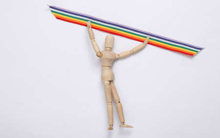 Puppets hold LGBT rainbow ribbon pride tape symbol on a pink background. love and peace. Stop...