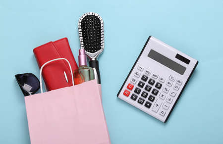 Shopping package with purchases and calculator on blue background. shopping conceptの写真素材