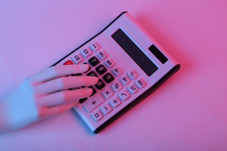 Hand uses Calculator in pink blue gradient neon lightの写真素材