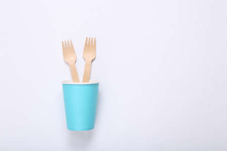 Cardboard cup with wooden forks on a white background. Eco conceptの写真素材