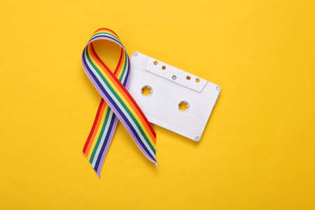 LGBT rainbow ribbon pride tape symbol with audio cassette on white background.の写真素材