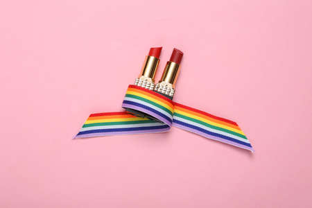 LGBT rainbow ribbon pride tape symbol and lipstick on pink background. top viewの写真素材
