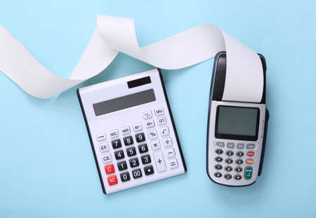 Pos terminal and calculator on blue background.