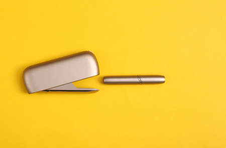 Tobacco heating system on yellow background.の写真素材