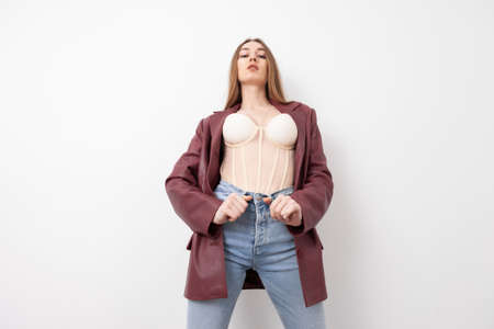 Portrait of a fashionable woman in stylish clothes on a white background