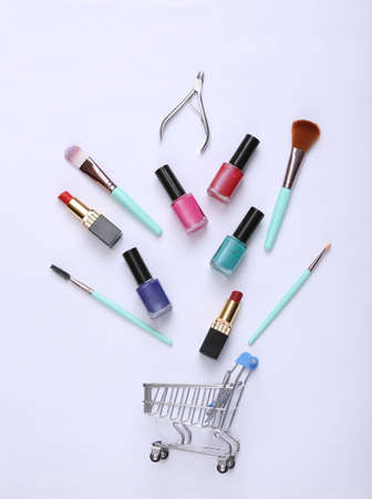Shopping trolley with different cosmetics on white background. top view. beauty still lifeの写真素材