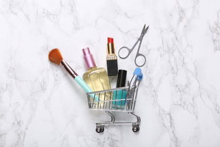 Shopping cart with beauty products on marble backgroundの写真素材