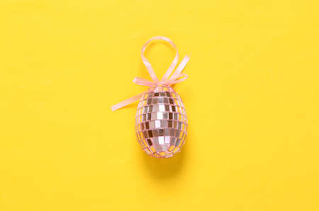 Mirrored egg on yellow background. creative easter layoutの写真素材