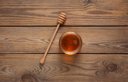Jar of honey bee with spoon on wooden background.の写真素材
