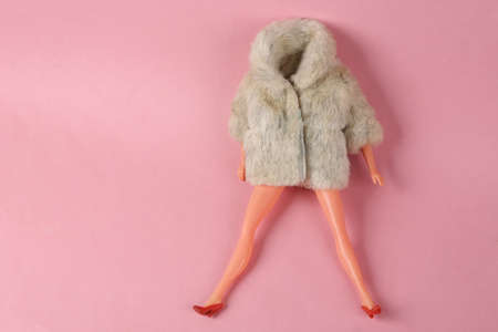 Doll mannequin in warm fur coat on pink background. Minimalism fashion shot.の写真素材