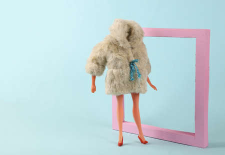 Doll mannequin in warm fur coat with frame. Minimalism fashion shot. concept artの写真素材