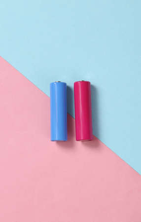 AA batteries on blue pink background. minimalismの写真素材