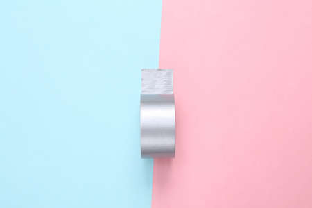 Roll of tape on a blue-pink pastel background. minimalism. top viewの写真素材